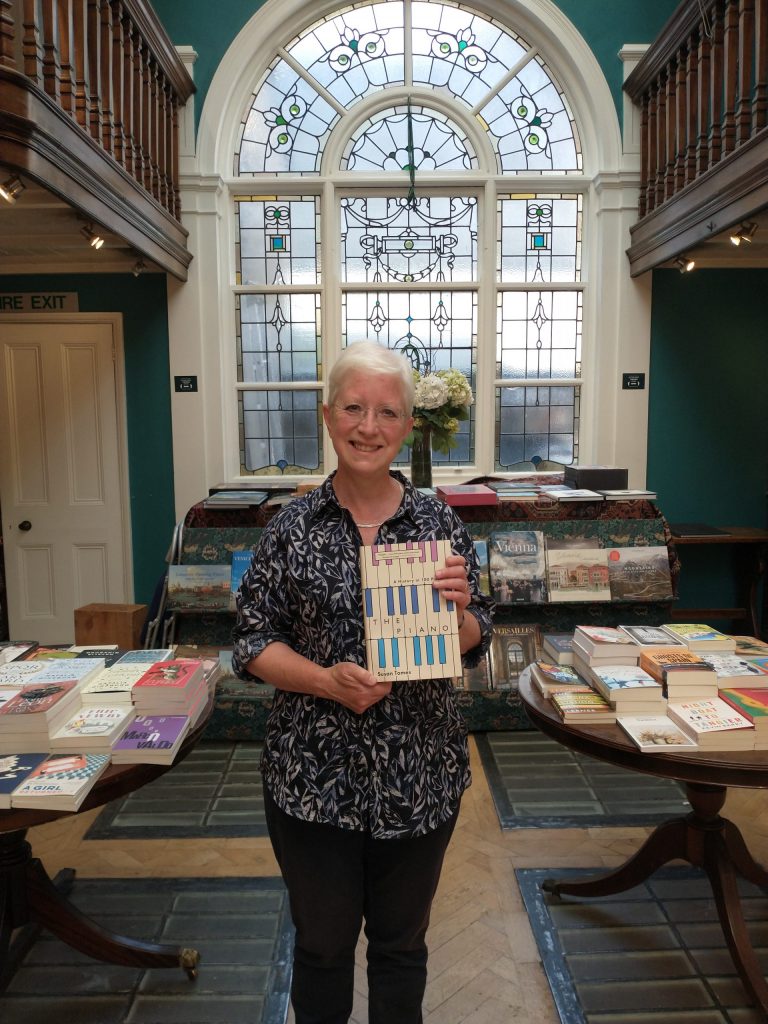 Susan Tomes holding her book, The Piano - A History in 100 Pieces